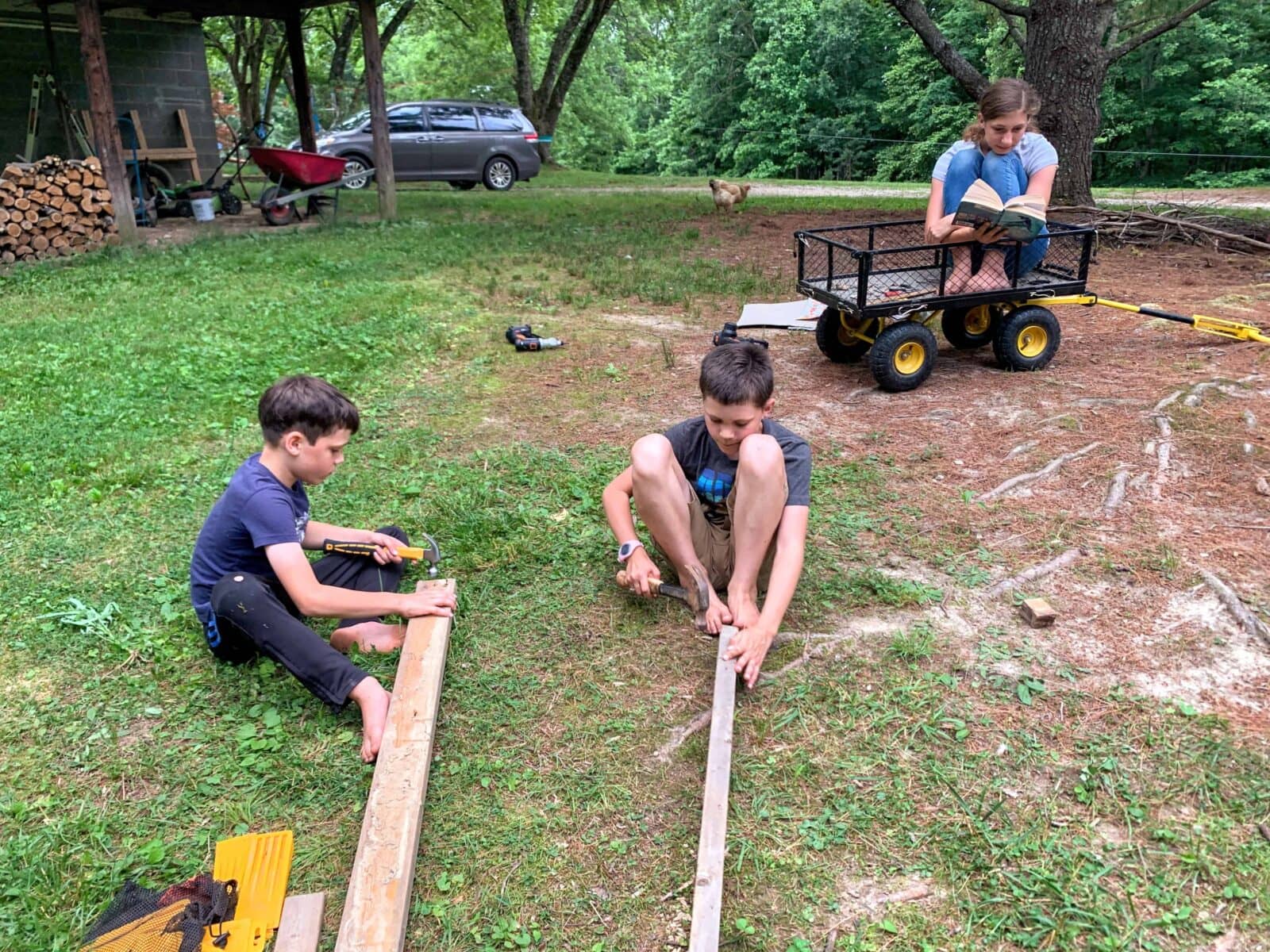 two boys pulling nails out of wood