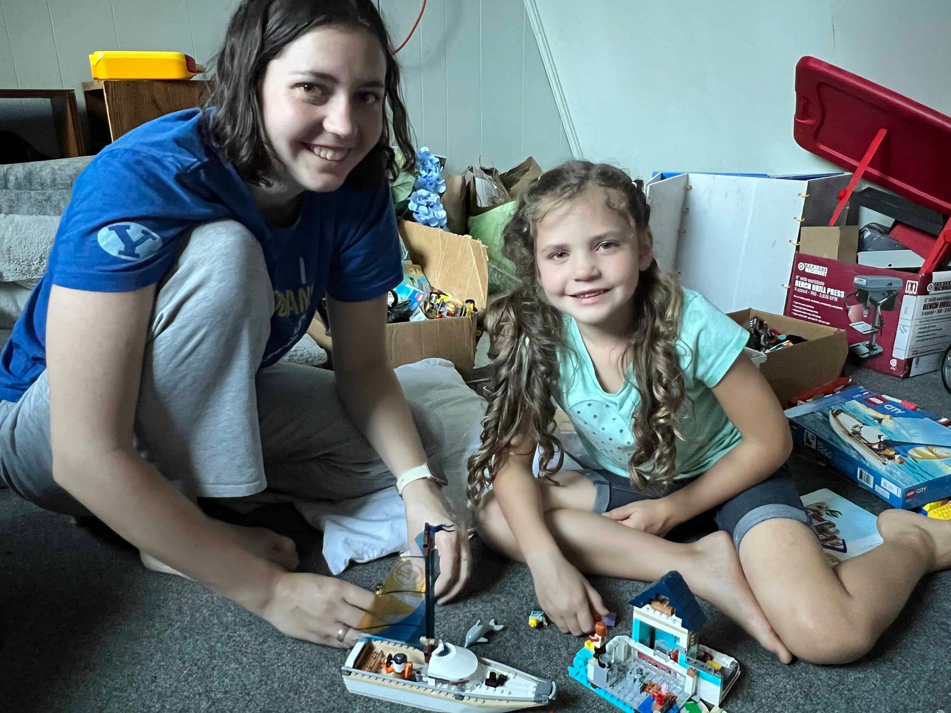 big sister playing Legos with little sister