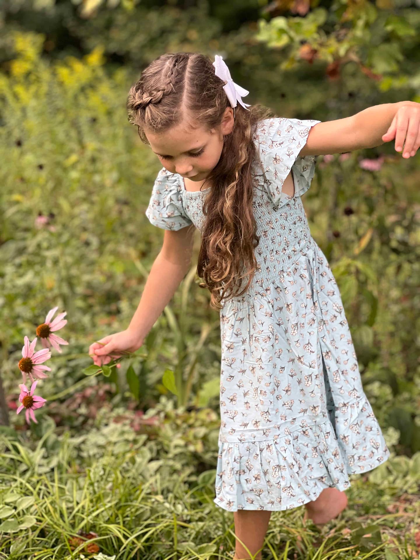 7 year old walking in a flower garden