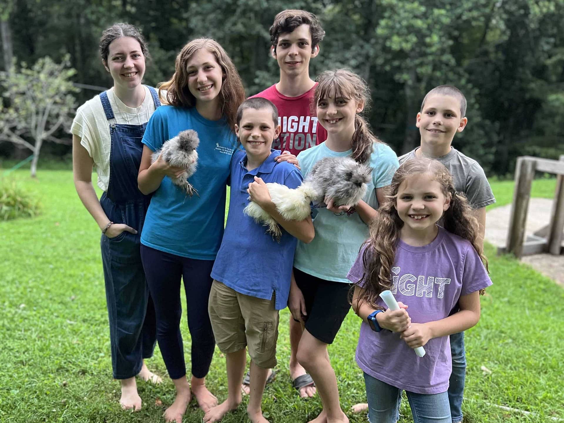 family of 7 kids holding chicks