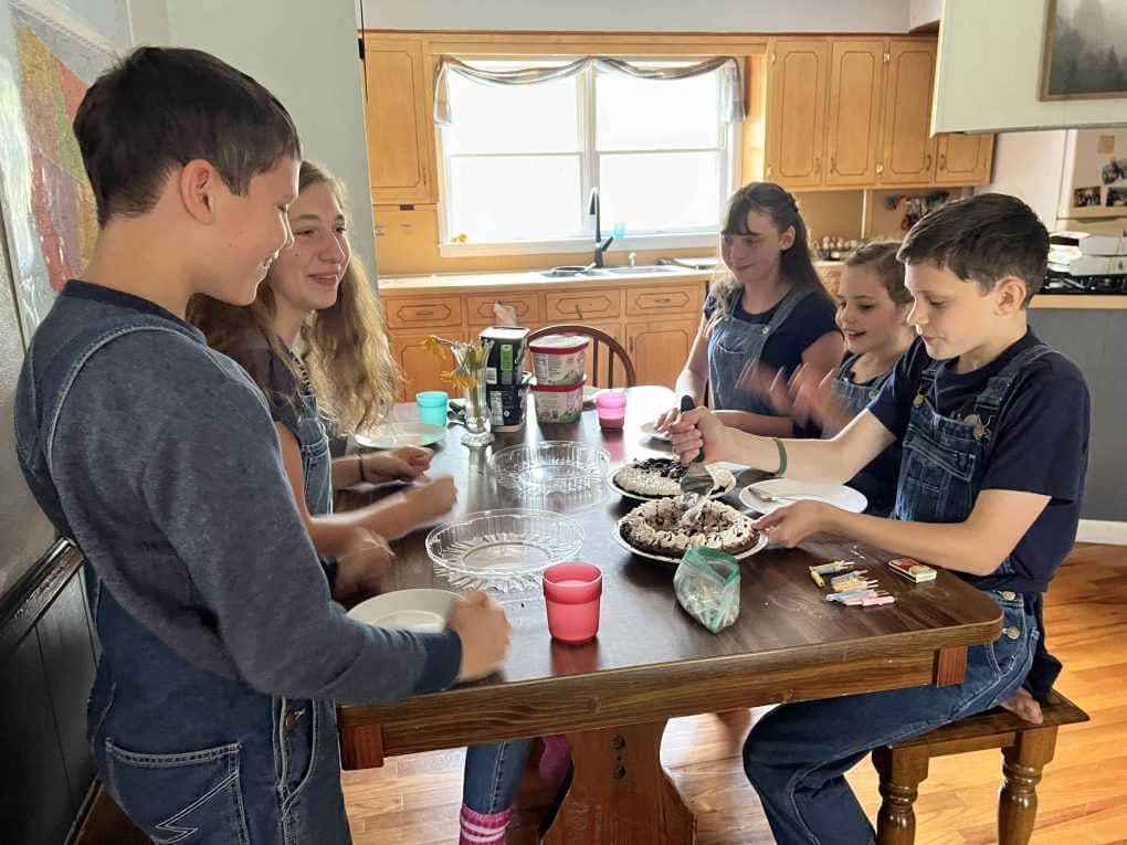 Kids eating pie at the table